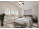 Staged bedroom features a vaulted ceiling, large windows, and a neutral color palette at 1016 Goldmist Ln, Durham, NC 27713