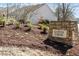Stone sign for Copper Creek community near townhomes, showing established, welcoming neighborhood with mature landscaping at 1016 Goldmist Ln, Durham, NC 27713