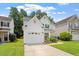 Charming home with a two-car garage, landscaped front yard, and sidewalk leading to the entrance at 1016 Goldmist Ln, Durham, NC 27713