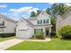 Charming two-story home with a well-manicured lawn, white siding, and green shutters at 1016 Goldmist Ln, Durham, NC 27713