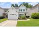 Charming two-story home featuring a garage, landscaped front yard, and green shutters at 1016 Goldmist Ln, Durham, NC 27713
