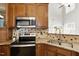 Kitchen featuring stainless steel appliances, granite countertops, and tile backsplash at 1016 Goldmist Ln, Durham, NC 27713