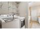 Convenient laundry room features a washer, dryer, and shelving for storage at 1016 Goldmist Ln, Durham, NC 27713