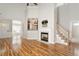 Open living room with wood floors, fireplace, and staircase to the upper level at 1016 Goldmist Ln, Durham, NC 27713