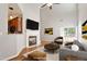 Bright living room features a fireplace, high ceilings, wood floors, and access to the outdoors at 1016 Goldmist Ln, Durham, NC 27713
