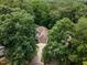 Aerial view of a home nestled among mature trees with a long driveway at 105 Gorge Ct, Cary, NC 27518