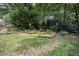 Landscaped backyard retreat with lush greenery, stone accents, and a cozy seating area at 105 Gorge Ct, Cary, NC 27518