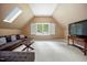 Large bonus room with a skylight, a comfortable sectional sofa, and a television at 105 Gorge Ct, Cary, NC 27518