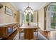 Elegant dining room with hardwood floors, stylish lighting, and large windows, perfect for Gathering gatherings at 105 Gorge Ct, Cary, NC 27518