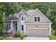 Inviting home exterior showcasing a two-car garage, manicured lawn, and elegant architectural details at 105 Gorge Ct, Cary, NC 27518
