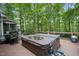 Wooden deck with hot tub and surrounding wooded scenery creating a private spa experience at 105 Gorge Ct, Cary, NC 27518