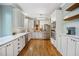Spacious kitchen with white cabinets, stainless steel appliances, and hardwood floors, perfect for cooking and entertaining at 105 Gorge Ct, Cary, NC 27518