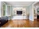 Stylish living room featuring built-in shelving, hardwood floors, and plenty of natural light, ideal for modern living at 105 Gorge Ct, Cary, NC 27518