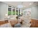 Bright living room with hardwood floors, large windows, and neutral decor, perfect for relaxing or entertaining at 105 Gorge Ct, Cary, NC 27518
