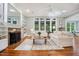 Cozy living room features a fireplace, hardwood floors, and large windows providing ample natural light at 105 Gorge Ct, Cary, NC 27518