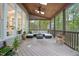 Relaxing screened-in porch with comfortable seating, wood ceiling and natural light at 105 Gorge Ct, Cary, NC 27518