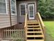Back entrance with a newly constructed wooden staircase and railing leading up to the door at 105 Perry Ln, Zebulon, NC 27597
