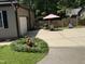Large patio and back yard featuring flower garden and an outdoor dining area at 105 Perry Ln, Zebulon, NC 27597