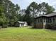 Spacious backyard featuring a storage shed and a partial view of the house at 105 Perry Ln, Zebulon, NC 27597