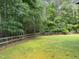 Spacious backyard featuring a chain link fence and lush green grass at 105 Perry Ln, Zebulon, NC 27597