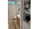 Bright bathroom with a shower, a storage cabinet, and a sink at 105 Perry Ln, Zebulon, NC 27597