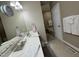 Bright bathroom featuring a double sink vanity, decorative mirror, and tile flooring at 105 Perry Ln, Zebulon, NC 27597