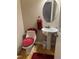 Cozy half bath featuring a red rug, toilet seat cover, and towel at 105 Perry Ln, Zebulon, NC 27597