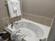 A luxurious white whirlpool bathtub with tile surround at 105 Perry Ln, Zebulon, NC 27597