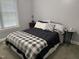 Neutral bedroom with a large window providing natural light at 105 Perry Ln, Zebulon, NC 27597