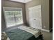 Bedroom featuring a double door closet and a large window providing natural light at 105 Perry Ln, Zebulon, NC 27597