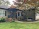 Charming home exterior with front porch, mature tree, and manicured lawn at 105 Perry Ln, Zebulon, NC 27597