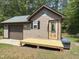 Charming exterior view of house with a garage, brown siding and a wooden porch at 105 Perry Ln, Zebulon, NC 27597