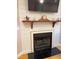 Cozy fireplace with shiplap surround and decorative mantel creates a warm atmosphere at 105 Perry Ln, Zebulon, NC 27597