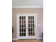 Elegant white French doors allowing natural light to illuminate the room, creating a bright feel at 105 Perry Ln, Zebulon, NC 27597