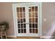 Elegant French doors provide a view of another room with wood floors at 105 Perry Ln, Zebulon, NC 27597