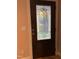 Elegant wood front door featuring decorative glass insert and sleek hardware at 105 Perry Ln, Zebulon, NC 27597