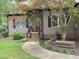 Inviting front exterior featuring a well-manicured lawn and charming front porch with decorative door at 105 Perry Ln, Zebulon, NC 27597