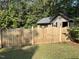 Charming fenced yard with wood gate and green lawn provides privacy and curb appeal at 105 Perry Ln, Zebulon, NC 27597