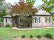 Charming home with a well-manicured lawn and a beautiful tree in the front yard at 105 Perry Ln, Zebulon, NC 27597