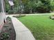 Inviting home with a well-manicured lawn, flower beds, and a sidewalk leading to the entrance at 105 Perry Ln, Zebulon, NC 27597