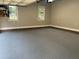 Garage with painted floors, windows for natural light, and brick trim at 105 Perry Ln, Zebulon, NC 27597