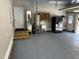 Garage with painted floor, water heater, utility sink, exterior door and steps leading to the door at 105 Perry Ln, Zebulon, NC 27597