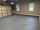 Attached garage features freshly epoxied flooring, storage shelving, and windows for natural light at 105 Perry Ln, Zebulon, NC 27597