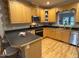 Kitchen featuring light wood cabinets, hardwood floors and stainless steel appliances at 105 Perry Ln, Zebulon, NC 27597
