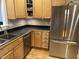 Functional kitchen showcasing stainless steel appliances, wooden cabinets, and efficient layout at 105 Perry Ln, Zebulon, NC 27597