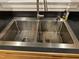Close up of a stainless steel kitchen sink with modern faucet and dish drying rack at 105 Perry Ln, Zebulon, NC 27597
