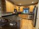 Traditional kitchen features light wood cabinetry, stainless steel appliances, and breakfast bar with seating at 105 Perry Ln, Zebulon, NC 27597