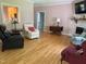 Bright living room featuring hardwood floors, fireplace, neutral walls, and comfortable seating at 105 Perry Ln, Zebulon, NC 27597