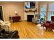 Spacious living room featuring a fireplace, hardwood floors, and a cozy sitting area at 105 Perry Ln, Zebulon, NC 27597
