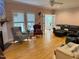 Spacious living room with hardwood floors, large windows, and comfortable seating at 105 Perry Ln, Zebulon, NC 27597